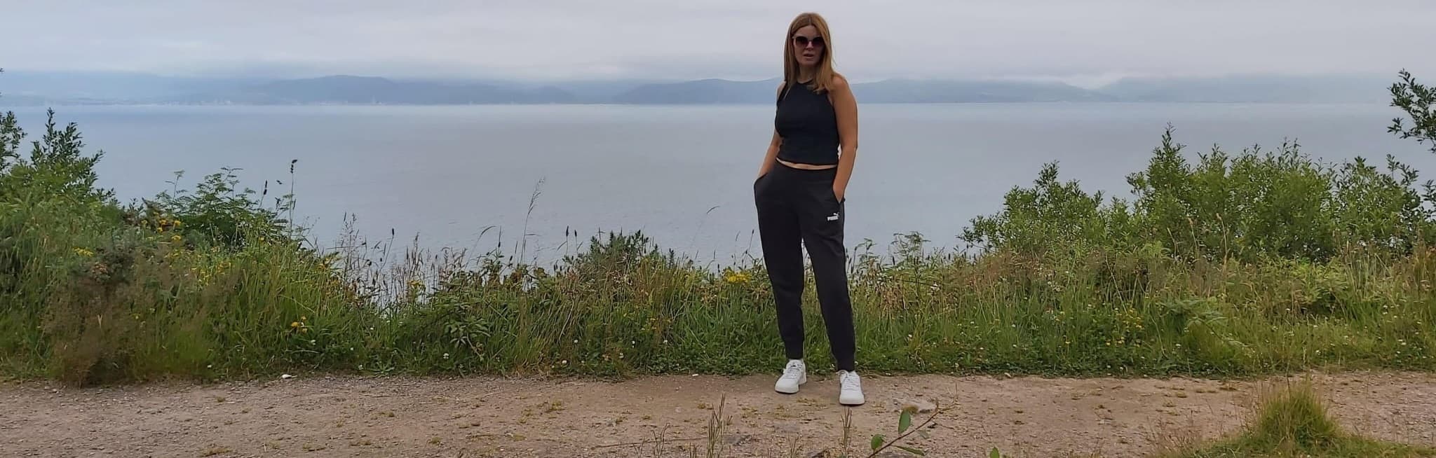 Aisling O'Donoghue standing on a coastal path overlooking the sea — healthier habits and a clearer mindset around food